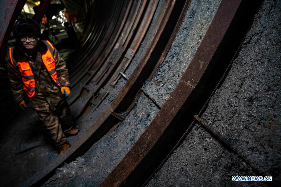 A worker walks at the construction site of Tianshan Shengli tunnel in northwest China's Xinjiang Uygur Autonomous Region, Feb. 4, 2021. Tianshan Shengli tunnel, with a total length of about 22 kilometers, is currently the longest highway tunnel under construction in China. Started in 2020, the tunnel, a six-year project on the Urumqi-Yuli highway, passes through a cold and high altitude zone, with harsh climate and geological condition. After completion and opened to traffic, it will provide safer and more convenient travel to the passengers and promote local economic and social development. (Xinhua/Hu Huhu)