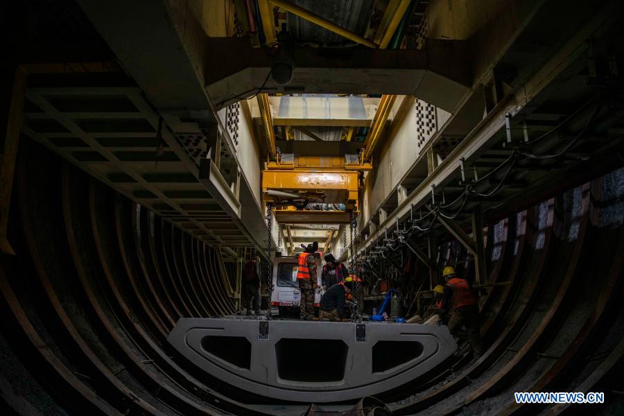 Workers lay inverted arches at the construction site of Tianshan Shengli tunnel in northwest China's Xinjiang Uygur Autonomous Region, Feb. 4, 2021. Tianshan Shengli tunnel, with a total length of about 22 kilometers, is currently the longest highway tunnel under construction in China. Started in 2020, the tunnel, a six-year project on the Urumqi-Yuli highway, passes through a cold and high altitude zone, with harsh climate and geological condition. After completion and opened to traffic, it will provide safer and more convenient travel to the passengers and promote local economic and social development. (Xinhua/Hu Huhu)