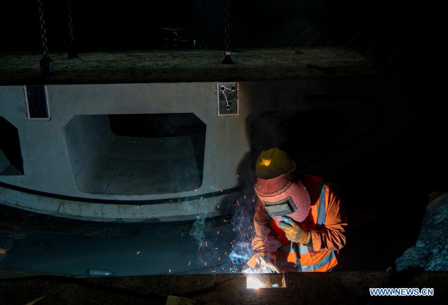 A worker performs welding operations at the construction site of Tianshan Shengli tunnel in northwest China's Xinjiang Uygur Autonomous Region, Feb. 3, 2021. Tianshan Shengli tunnel, with a total length of about 22 kilometers, is currently the longest highway tunnel under construction in China. Started in 2020, the tunnel, a six-year project on the Urumqi-Yuli highway, passes through a cold and high altitude zone, with harsh climate and geological condition. After completion and opened to traffic, it will provide safer and more convenient travel to the passengers and promote local economic and social development. (Xinhua/Hu Huhu)