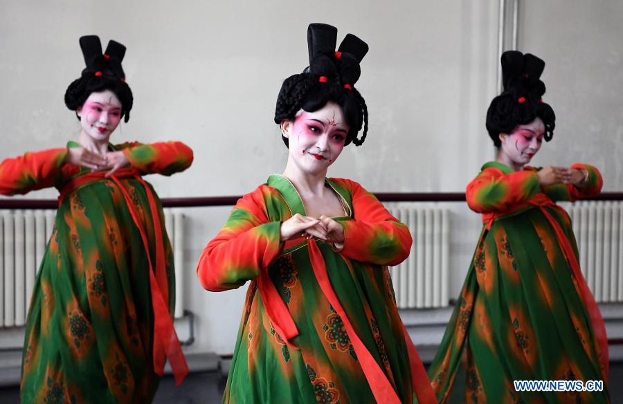 Dancers practice at Zhengzhou Song and Dance Theater in Zhengzhou, central China's Henan Province, Feb. 20, 2021. Fourteen dancers from Zhengzhou Song and Dance Theater have been very busy since the dancing they performed went viral online. The performance, named Banquet of Tang Palace, was staged at the Spring Festival gala of Henan Province. Brilliantly choreographed and acted, the dancing has almost brought ancient dancing figurines of the Tang Dynasty (618-907) alive. The performance Banquet of Tang Palace, inspired by the dancing figurines displayed at a museum, tells a story about the life of female musicians during the Tang Dynasty. 