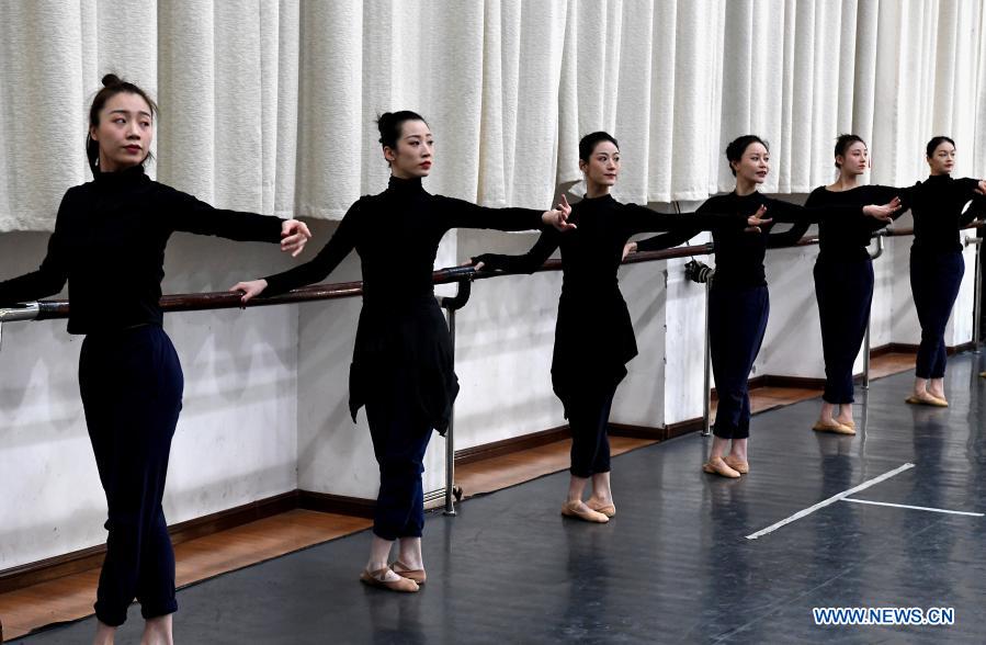 Dancers practice at Zhengzhou Song and Dance Theater in Zhengzhou, central China's Henan Province, Feb. 20, 2021. Fourteen dancers from Zhengzhou Song and Dance Theater have been very busy since the dancing they performed went viral online. The performance, named Banquet of Tang Palace, was staged at the Spring Festival gala of Henan Province. Brilliantly choreographed and acted, the dancing has almost brought ancient dancing figurines of the Tang Dynasty (618-907) alive. The performance Banquet of Tang Palace, inspired by the dancing figurines displayed at a museum, tells a story about the life of female musicians during the Tang Dynasty. 