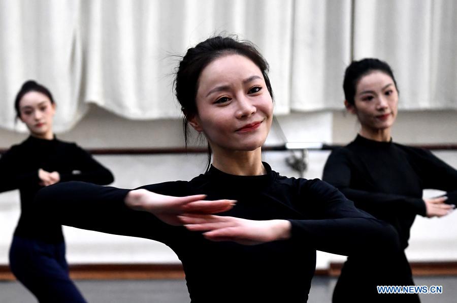 Yi Xingyan (C), leading actress of Zhengzhou Song and Dance Theater, practices at the theater in Zhengzhou, central China's Henan Province, Feb. 20, 2021. Fourteen dancers from Zhengzhou Song and Dance Theater have been very busy since the dancing they performed went viral online. The performance, named Banquet of Tang Palace, was staged at the Spring Festival gala of Henan Province. Brilliantly choreographed and acted, the dancing has almost brought ancient dancing figurines of the Tang Dynasty (618-907) alive. The performance Banquet of Tang Palace, inspired by the dancing figurines displayed at a museum, tells a story about the life of female musicians during the Tang Dynasty. 