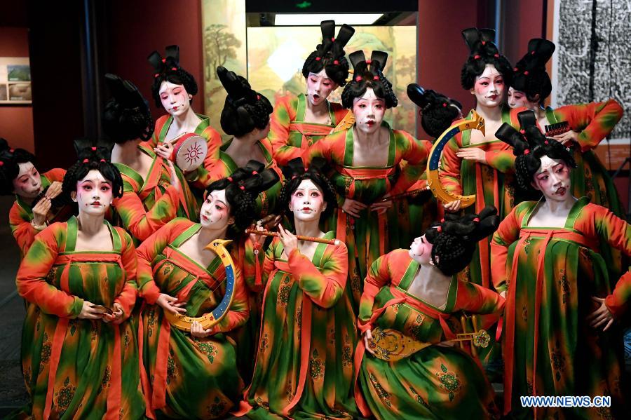 Dancers pose for photos during the recording of a program at Henan Museum in Zhengzhou, central China's Henan Province, Feb. 20, 2021. Fourteen dancers from Zhengzhou Song and Dance Theater have been very busy since the dancing they performed went viral online. The performance, named Banquet of Tang Palace, was staged at the Spring Festival gala of Henan Province. Brilliantly choreographed and acted, the dancing has almost brought ancient dancing figurines of the Tang Dynasty (618-907) alive. The performance Banquet of Tang Palace, inspired by the dancing figurines displayed at a museum, tells a story about the life of female musicians during the Tang Dynasty. 