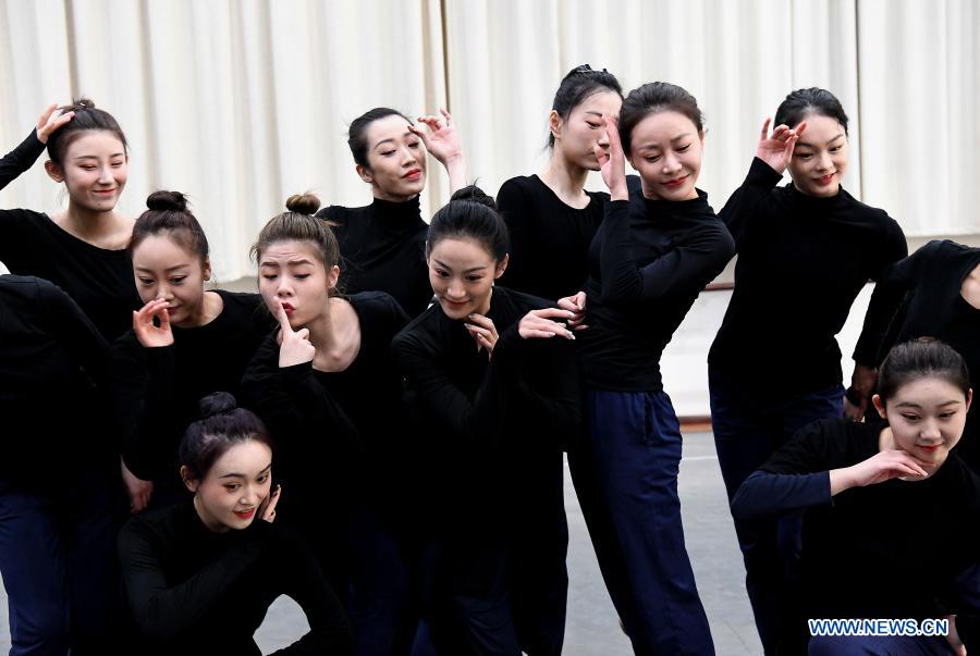 Dancers practice at Zhengzhou Song and Dance Theater in Zhengzhou, central China's Henan Province, Feb. 20, 2021. Fourteen dancers from Zhengzhou Song and Dance Theater have been very busy since the dancing they performed went viral online. The performance, named Banquet of Tang Palace, was staged at the Spring Festival gala of Henan Province. Brilliantly choreographed and acted, the dancing has almost brought ancient dancing figurines of the Tang Dynasty (618-907) alive. The performance Banquet of Tang Palace, inspired by the dancing figurines displayed at a museum, tells a story about the life of female musicians during the Tang Dynasty. 