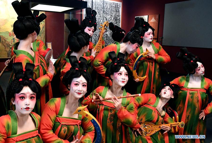 Dancers pose for photos during the recording of a program at Henan Museum in Zhengzhou, central China's Henan Province, Feb. 20, 2021. Fourteen dancers from Zhengzhou Song and Dance Theater have been very busy since the dancing they performed went viral online. The performance, named Banquet of Tang Palace, was staged at the Spring Festival gala of Henan Province. Brilliantly choreographed and acted, the dancing has almost brought ancient dancing figurines of the Tang Dynasty (618-907) alive. The performance Banquet of Tang Palace, inspired by the dancing figurines displayed at a museum, tells a story about the life of female musicians during the Tang Dynasty. 