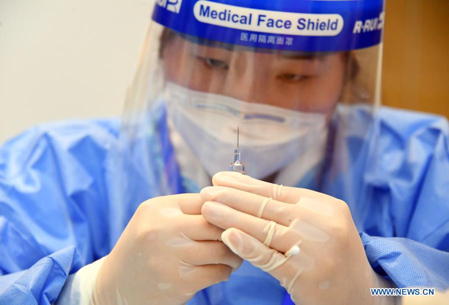 A medical worker prepares a vaccine at a temporary COVID-19 vaccination site at a company in the ZPark Phase 2 in Haidian District of Beijing, capital of China, Feb. 22, 2021. It is expected to take two days to complete the vaccination of more than 3,800 employees of the enterprise. (Xinhua/Ren Chao)