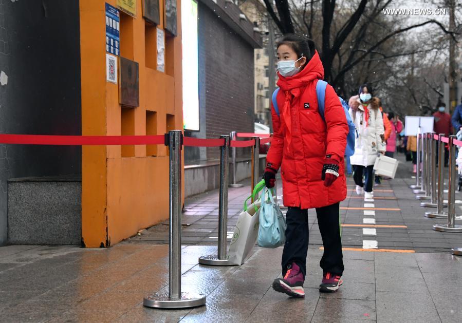 Students walk into the campus of Beijing Taipinglu Primary school in Haidian District of Beijing, capital of China, March 1, 2021. Middle school and primary school students returned to school as scheduled for the spring semester in Beijing on Monday amid coordinated epidemic control efforts. (Xinhua/Ren Chao)