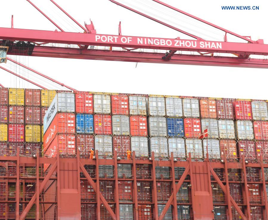 Staff members work at the Ningbo Zhoushan Port in Ningbo, east China's Zhejiang Province, March 3, 2021. Both cargo and container throughput of Ningbo Zhoushan Port registered year-on-year growth of 4.7 percent and 4.3 percent respectively in 2020. The port saw its cargo throughput reach 1.172 billion tons while the container throughput achieved 28.72 million twenty-foot equivalent units (TEUs) last year. (Xinhua/Weng Xinyang)