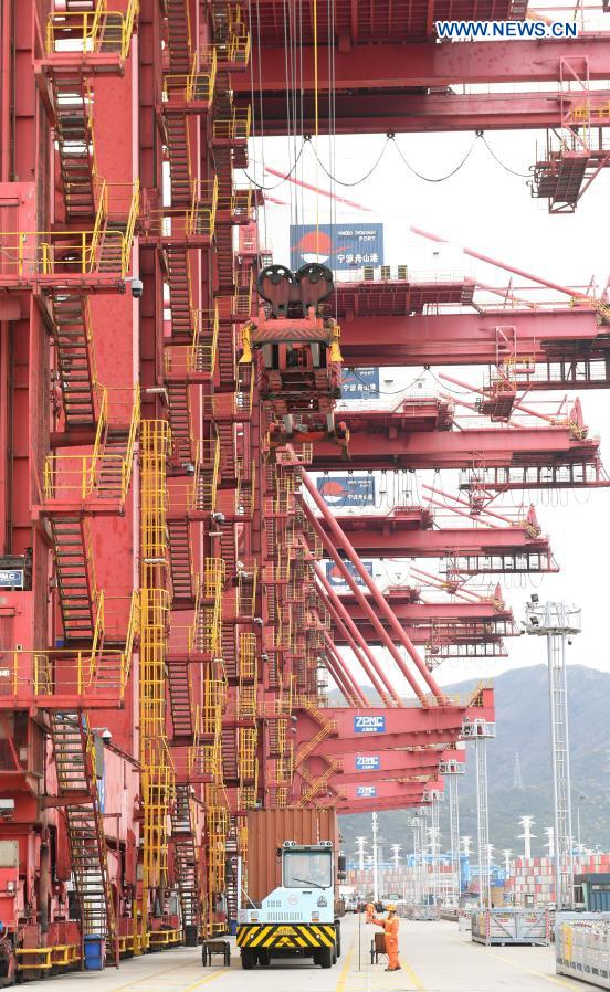 Staff members work at the Ningbo Zhoushan Port in Ningbo, east China's Zhejiang Province, March 3, 2021. Both cargo and container throughput of Ningbo Zhoushan Port registered year-on-year growth of 4.7 percent and 4.3 percent respectively in 2020. The port saw its cargo throughput reach 1.172 billion tons while the container throughput achieved 28.72 million twenty-foot equivalent units (TEUs) last year. (Xinhua/Weng Xinyang)