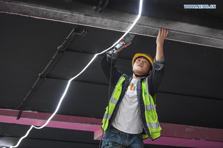 A worker is busy at the construction site of an enterprise port project in Jiangdong New Area of Haikou, south China's Hainan Province, March 3, 2021. The project is designed as a low-density and garden-style office park. (Xinhua/Pu Xiaoxu)