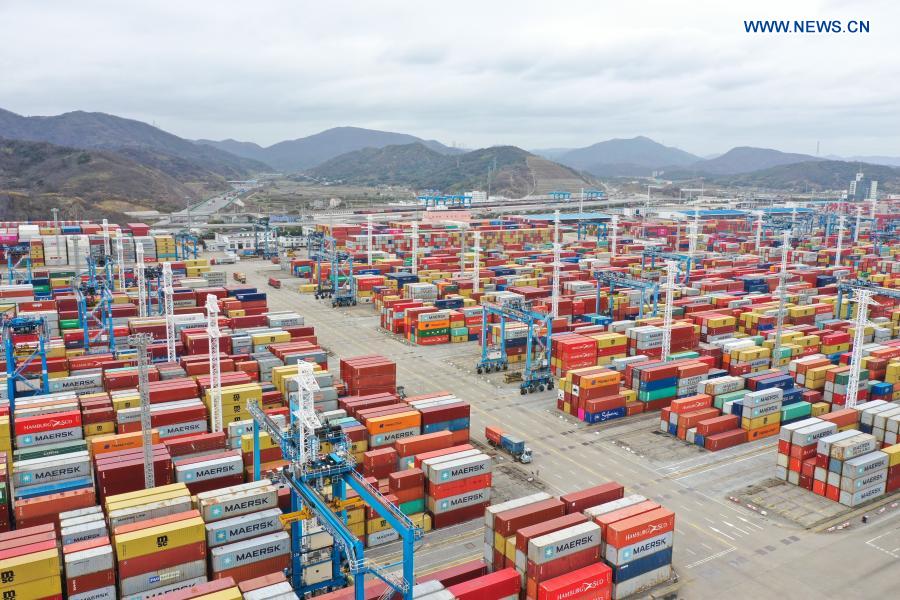 Aerial photo taken on March 3, 2021 shows containers piled up at the Ningbo Zhoushan Port in Ningbo, east China's Zhejiang Province. Both cargo and container throughput of Ningbo Zhoushan Port registered year-on-year growth of 4.7 percent and 4.3 percent respectively in 2020. The port saw its cargo throughput reach 1.172 billion tons while the container throughput achieved 28.72 million twenty-foot equivalent units (TEUs) last year. (Xinhua/Weng Xinyang)
