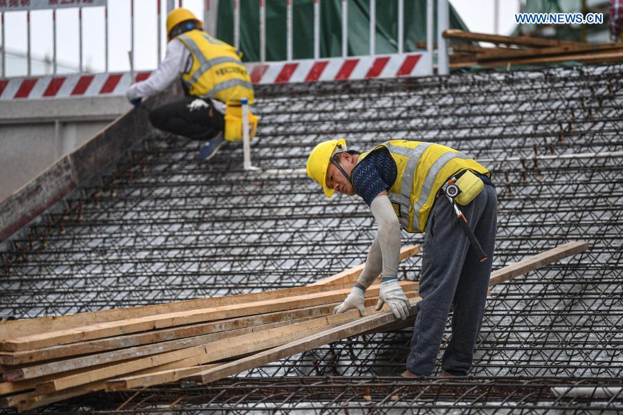 Workers are busy at the construction site of an enterprise port project in Jiangdong New Area of Haikou, south China's Hainan Province, March 3, 2021. The project is designed as a low-density and garden-style office park. (Xinhua/Pu Xiaoxu)