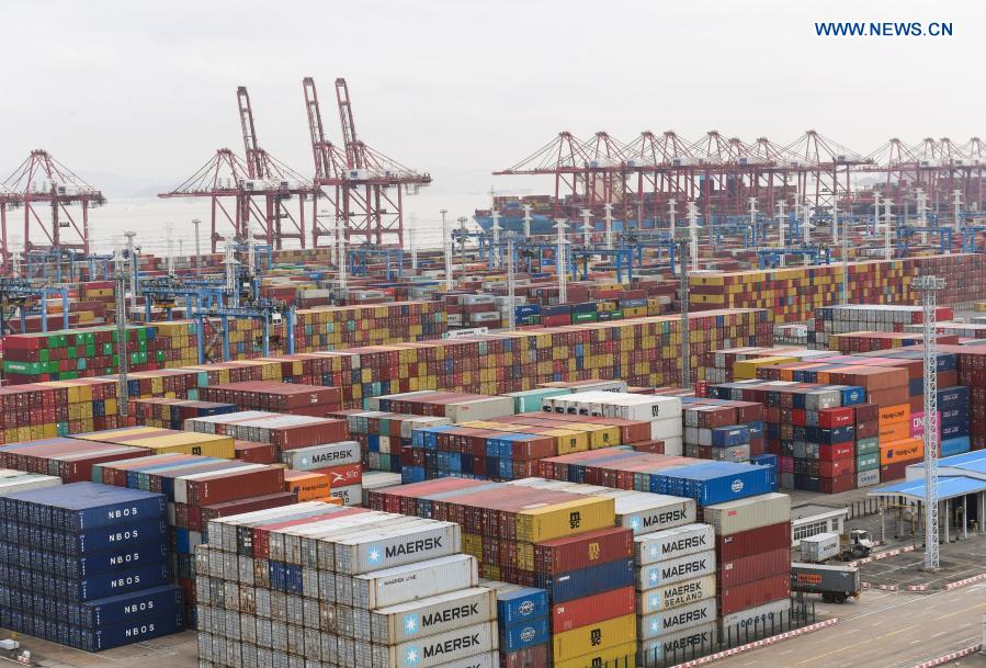 Aerial photo taken on March 3, 2021 shows containers piled up at the Ningbo Zhoushan Port in Ningbo, east China's Zhejiang Province. Both cargo and container throughput of Ningbo Zhoushan Port registered year-on-year growth of 4.7 percent and 4.3 percent respectively in 2020. The port saw its cargo throughput reach 1.172 billion tons while the container throughput achieved 28.72 million twenty-foot equivalent units (TEUs) last year. (Xinhua/Weng Xinyang)