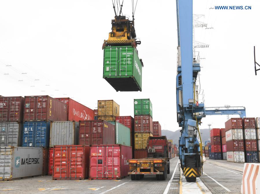 The crane lifts a container at the Ningbo Zhoushan Port in Ningbo, east China's Zhejiang Province, March 3, 2021. Both cargo and container throughput of Ningbo Zhoushan Port registered year-on-year growth of 4.7 percent and 4.3 percent respectively in 2020. The port saw its cargo throughput reach 1.172 billion tons while the container throughput achieved 28.72 million twenty-foot equivalent units (TEUs) last year. (Xinhua/Weng Xinyang)