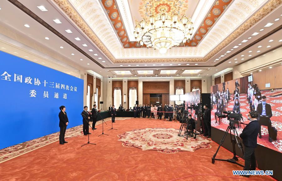 Members of the 13th National Committee of the Chinese People's Political Consultative Conference (CPPCC) are interviewed via video link ahead of the second plenary meeting of the fourth session of the 13th CPPCC National Committee at the Great Hall of the People in Beijing, capital of China, March 7, 2021. (Xinhua/Li Xin)