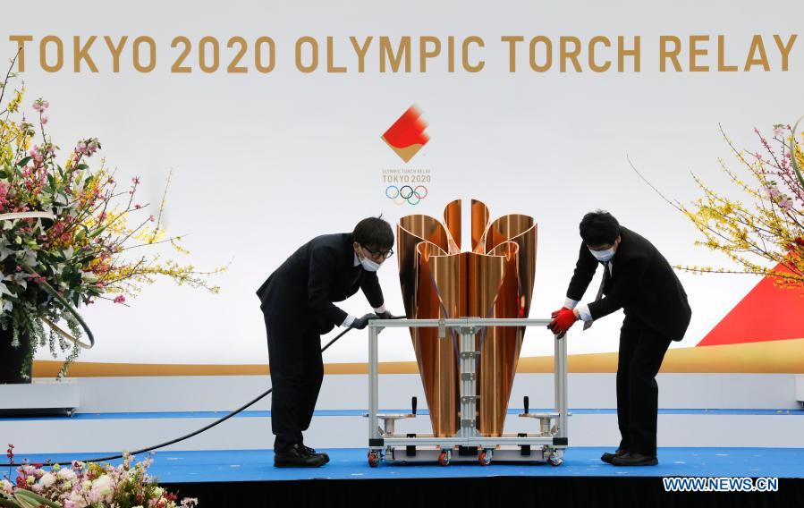 Staff memebers prepare the stage ahead of the opening ceremony on the first day of the Tokyo 2020 Olympic torch relay in Naraha, Fukushima of Japan, on March 25, 2021. (Kim Kyung-Hoon/Pool via Xinhua)