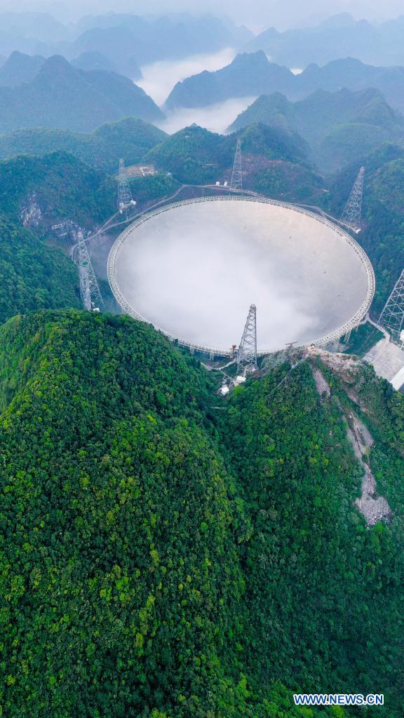 Aerial photo taken on March 31, 2021 shows China's Five-hundred-meter Aperture Spherical Radio Telescope (FAST) under maintenance in southwest China's Guizhou Province. China's FAST officially opened to the world starting Wednesday. (Xinhua/Ou Dongqu)