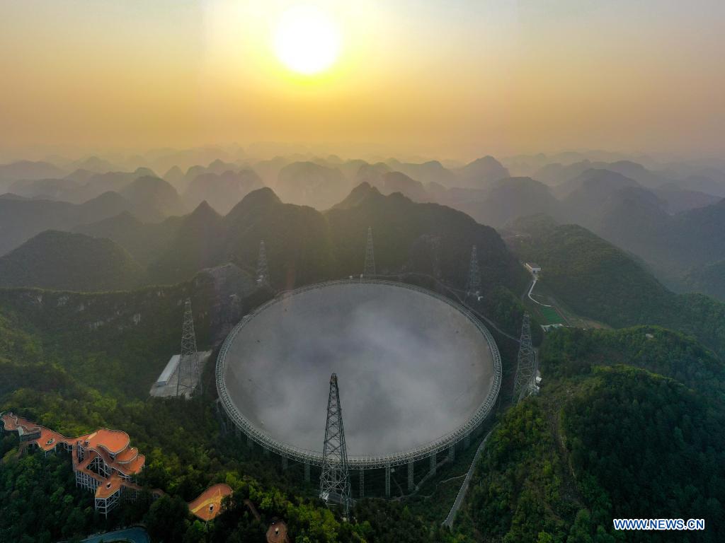 Aerial photo taken on March 31, 2021 shows China's Five-hundred-meter Aperture Spherical Radio Telescope (FAST) under maintenance in southwest China's Guizhou Province. China's FAST officially opened to the world starting Wednesday. (Xinhua/Ou Dongqu)