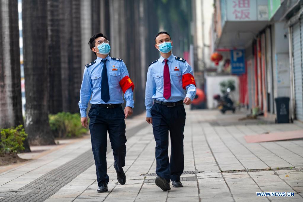 Two staff members patrol on a street in Ruili City, southwest China's Yunnan Province, April 5, 2021. Frontline medical workers, epidemic prevention and control personnel, border patrol personnel and volunteers from all walks of life work hard to control the spread of the novel coronavirus after new cluster infections were reported late March. (Xinhua/Chen Xinbo)