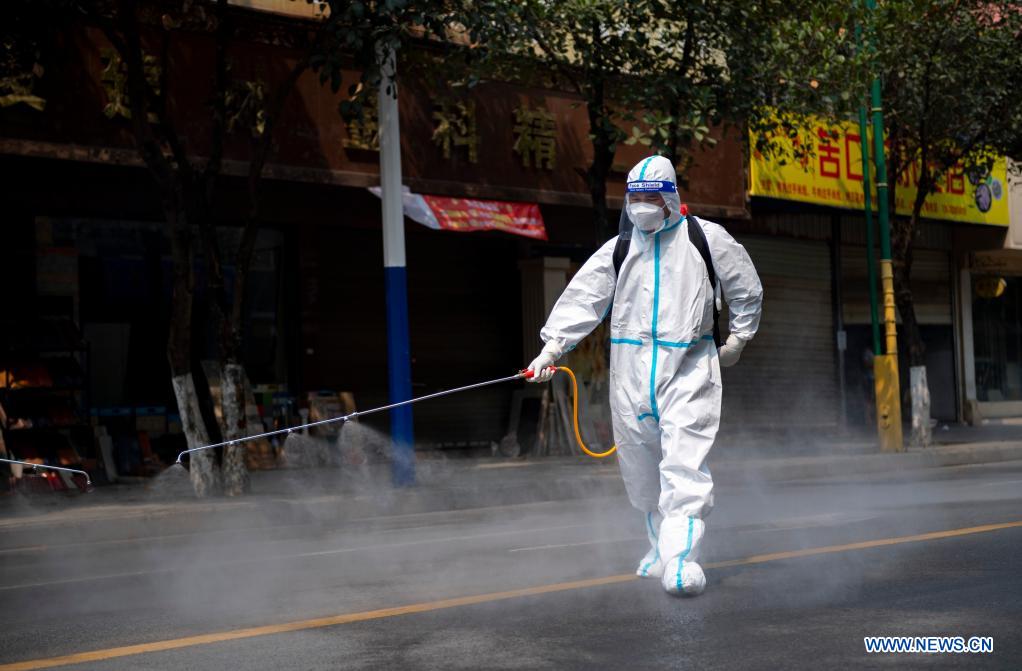 A staff member sprays disinfectant on a street in Ruili City, southwest China's Yunnan Province, April 7, 2021. Frontline medical workers, epidemic prevention and control personnel, border patrol personnel and volunteers from all walks of life work hard to control the spread of the novel coronavirus after new cluster infections were reported late March. (Xinhua/Chen Xinbo)