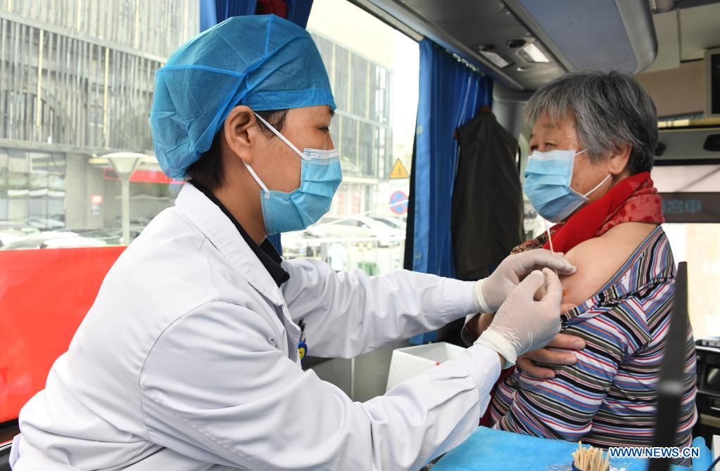 A medical worker injects a local resident with a dose of COVID-19 vaccine in a mobile vaccination vehicle in Haidian District of Beijing, capital of China, April 11, 2021. Beijing and Shanghai have deployed mobile vaccination vehicles in downtown areas. The bus-like facilities, equipped with vaccination stations, medical refrigerators and first-aid equipment, have been rolled out to save time and improve inoculation efficiency. (Xinhua/Ren Chao)