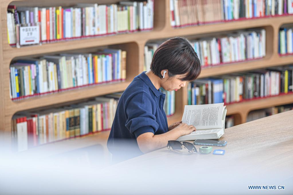 A reader is seen at the Wormhole Library in the Haikou Bay in Haikou, capital city of south China's Hainan Province on April 13, 2021. The Wormhole Library, designed as a landmark building in the Haikou Bay, opened to public on Tuesday. (Xinhua/Pu Xiaoxu)