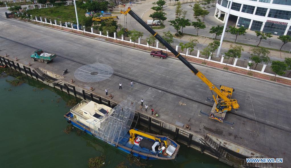 Aerial photo taken on Nov. 18, 2020 shows a crane lifting reef-like artificial coral reef nurseries onto a ship in Yazhou Bay of Sanya, south China's Hainan Province. The ecological restoration demonstration in Yazhou Bay has achieved initial effects. The project is proposed based on the urgent need for the restoration of Hainan coastal ecosystem. Researchers carry out systematic ecological restoration activities for the coral reef ecosystem around Dongluo Island. Thanks to researchers' work, the survival rate of coral has reached more than 70 percent. And the coral coverage rate has increased by 10 percent. (Xinhua/Yang Guanyu)