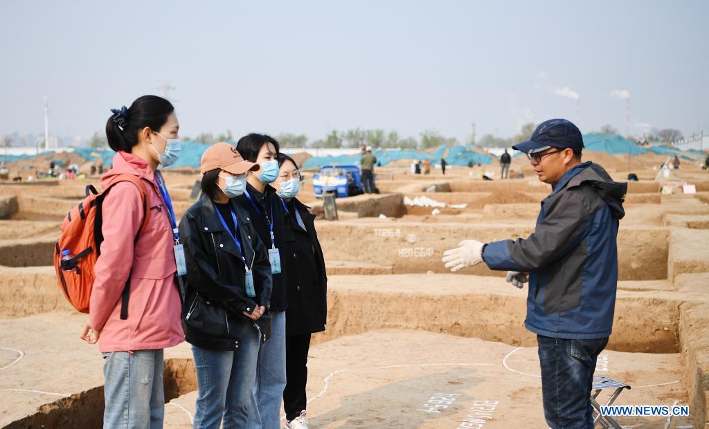 Shen Wenxi explains points to archeological enthusiasts at a site in Anyang, central China's Henan Province, April 8, 2021. Anyang is listed as one of the 