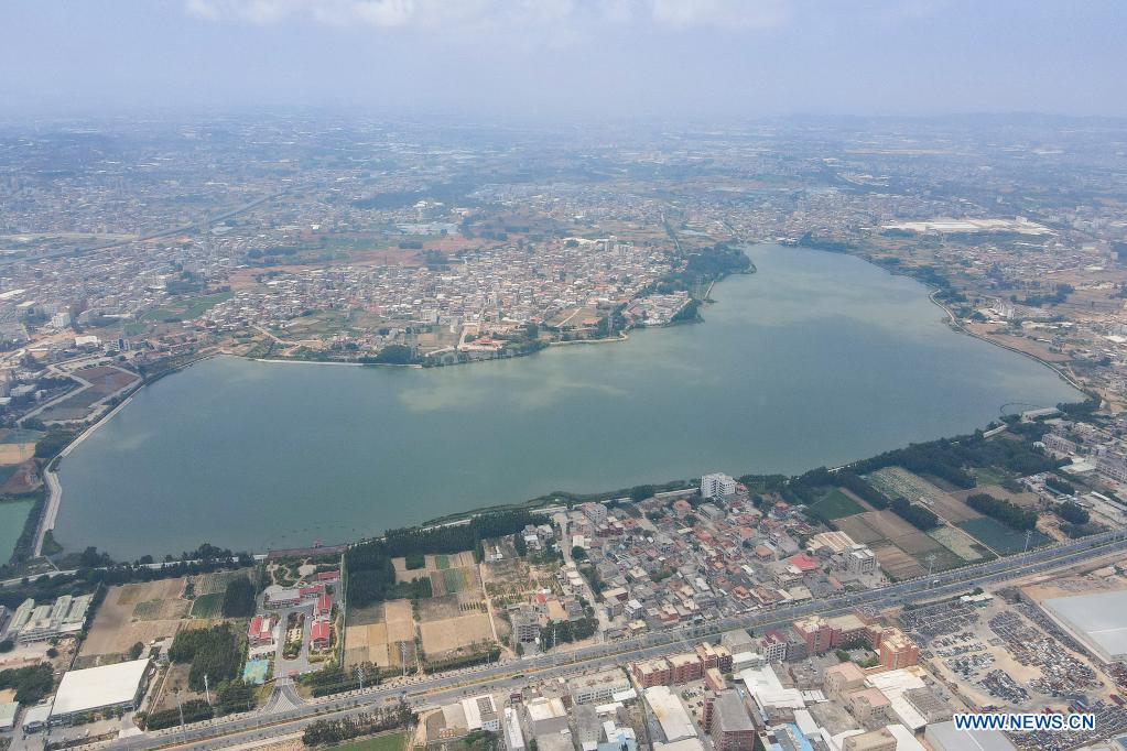 Aerial photo taken on April 13, 2021 shows Longhu Lake in Jinjiang City, the source of a water-diversion project connecting the Chinese mainland coastal province of Fujian to the island of Kinmen in Jinjiang, southeast China's Fujian Province. The water pipeline connecting Fujian to Kinmen went into operation in 2018, delivering water from Fujian's Jinjiang River to alleviate water shortages. (Photo by Lai Jincai/Xinhua)