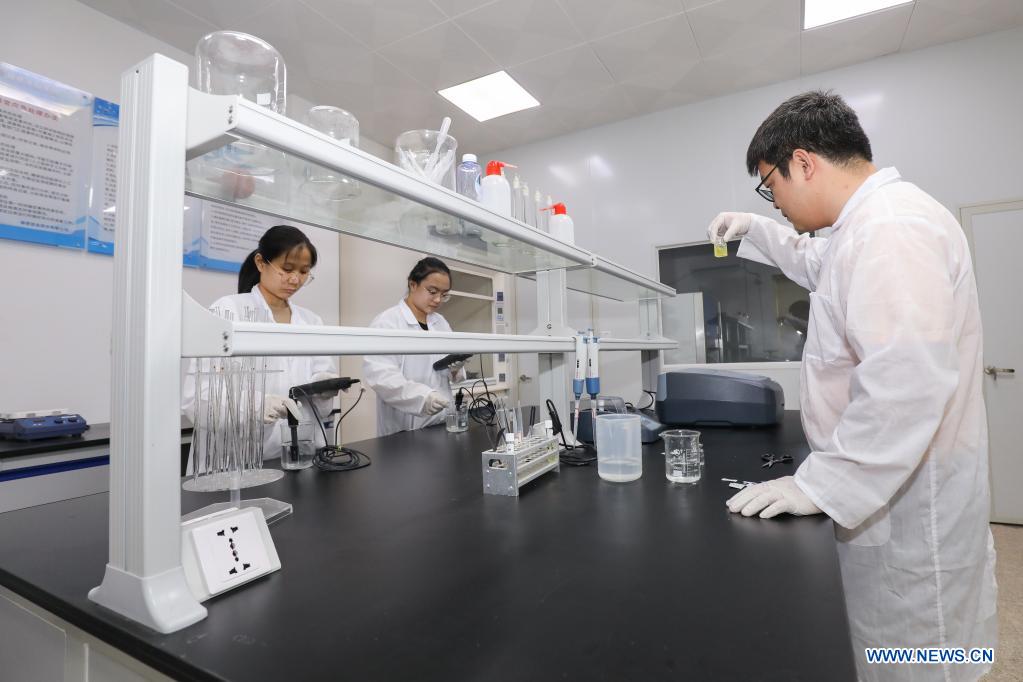 Staff examine the water sample at the water-diversion project connecting Fujian Province to the island of Kinmen in Jinjiang, southeast China's Fujian Province, April 13, 2021. The water pipeline connecting Fujian to Kinmen went into operation in 2018, delivering water from Fujian's Jinjiang River to alleviate water shortages. (Photo by Lai Jincai/Xinhua)