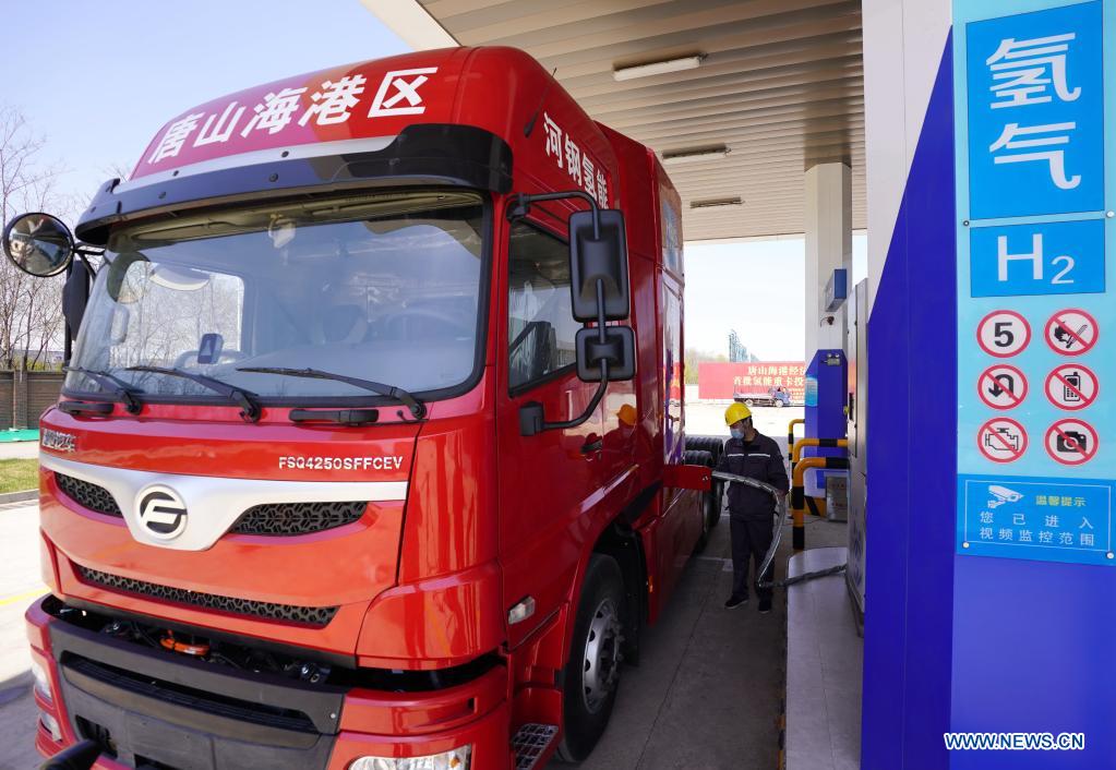 A worker refuels a hydrogen-powered heavy-duty truck at a hydrogen station in the Tangshan Haigang Economic Development Zone of Tangshan, north China's Hebei Province, April 14, 2021. Five hydrogen-powered heavy-duty trucks have been introduced on Wednesday by the Tangshan Haigang Economic Development Zone. The fleet of trucks are among the zone's first attempts to optimize its industrial structure and energy consumption by gradually replacing diesel fuel with the more eco-friendly hydrogen power cells. (Xinhua/Yang Shiyao)