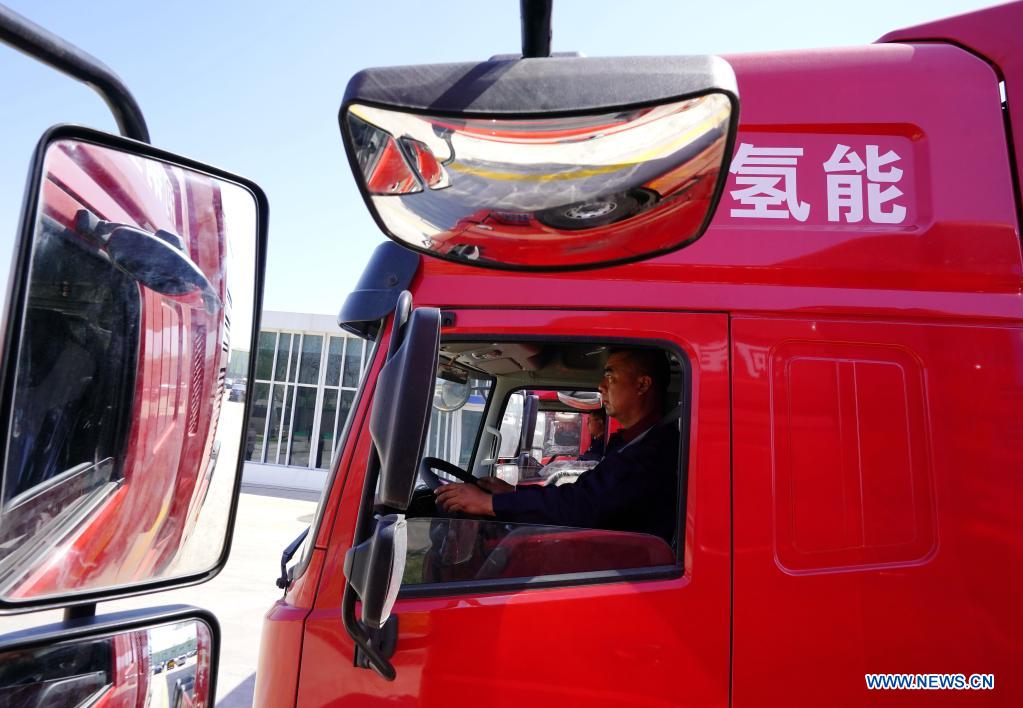 A worker drives a hydrogen-powered heavy-duty truck in the Tangshan Haigang Economic Development Zone of Tangshan, north China's Hebei Province, April 14, 2021. Five hydrogen-powered heavy-duty trucks have been introduced on Wednesday by the Tangshan Haigang Economic Development Zone. The fleet of trucks are among the zone's first attempts to optimize its industrial structure and energy consumption by gradually replacing diesel fuel with the more eco-friendly hydrogen power cells. (Xinhua/Yang Shiyao)