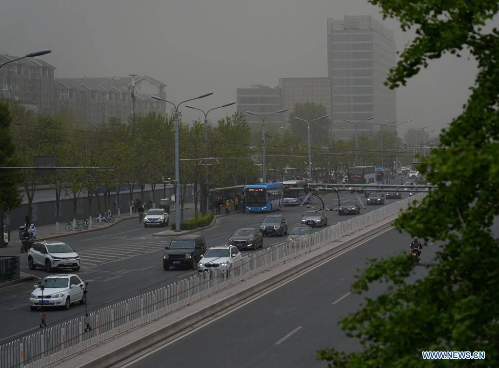 Photo taken on April 15, 2021 shows roads and buildings amid floating sand and dust in Beijing, capital of China. China's national observatory on Wednesday issued a blue alert for sandstorms in the northern part of the country. (Xinhua/Zhang Chenlin)