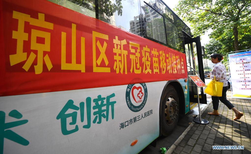 A COVID-19 vaccine recipient gets into a mobile vaccination station in Qiongshan District of Haikou, south China's Hainan Province, April 15, 2021. Vaccination against COVID-19 has been made easier for Haikou residents as 20 bus-turned mobile vaccination stations were recently introduced at the service of vaccine recipients in need. (Xinhua/Guo Cheng)