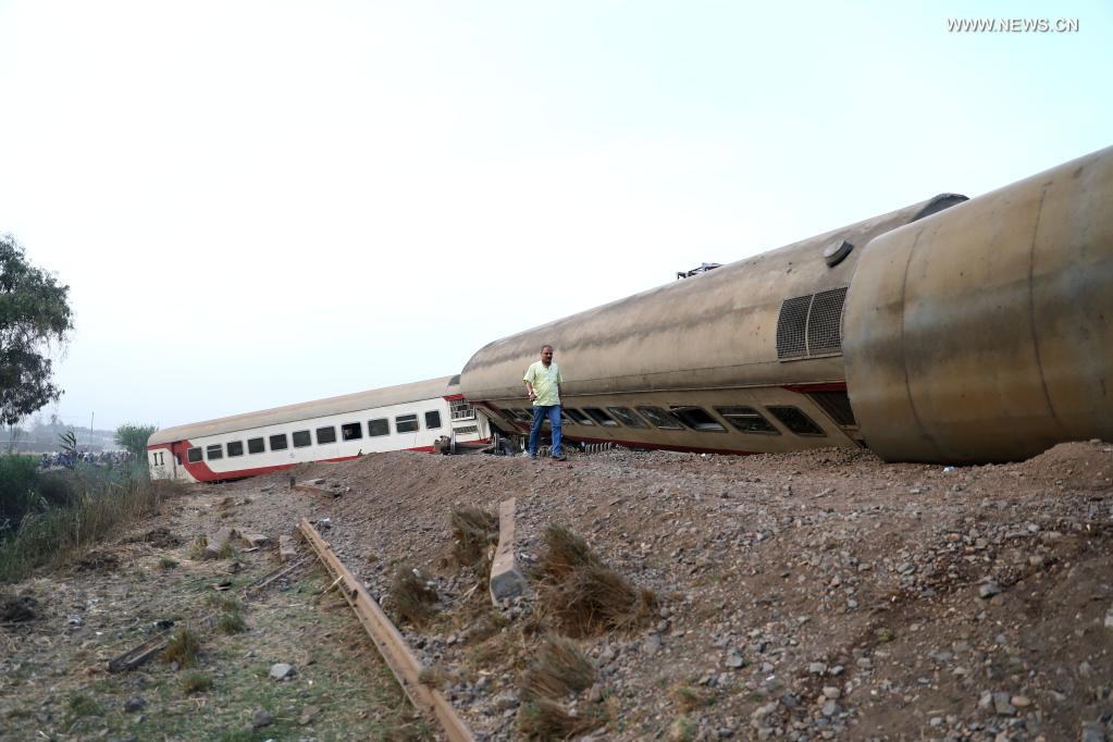 A man walks past a derailed train in the Delta city of Toukh, Egypt, on April 18, 2021. At least 97 people were wounded in a train derailment on Sunday in the Delta city of Toukh, north of the Egyptian capital Cairo, the Egyptian Health Ministry said. (Xinhua/Ahmed Gomaa)