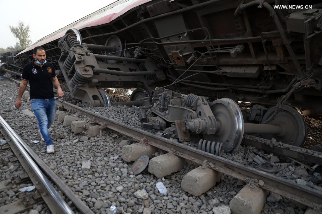 A man walks past a derailed train in the Delta city of Toukh, Egypt, on April 18, 2021. At least 97 people were wounded in a train derailment on Sunday in the Delta city of Toukh, north of the Egyptian capital Cairo, the Egyptian Health Ministry said. (Xinhua/Ahmed Gomaa)