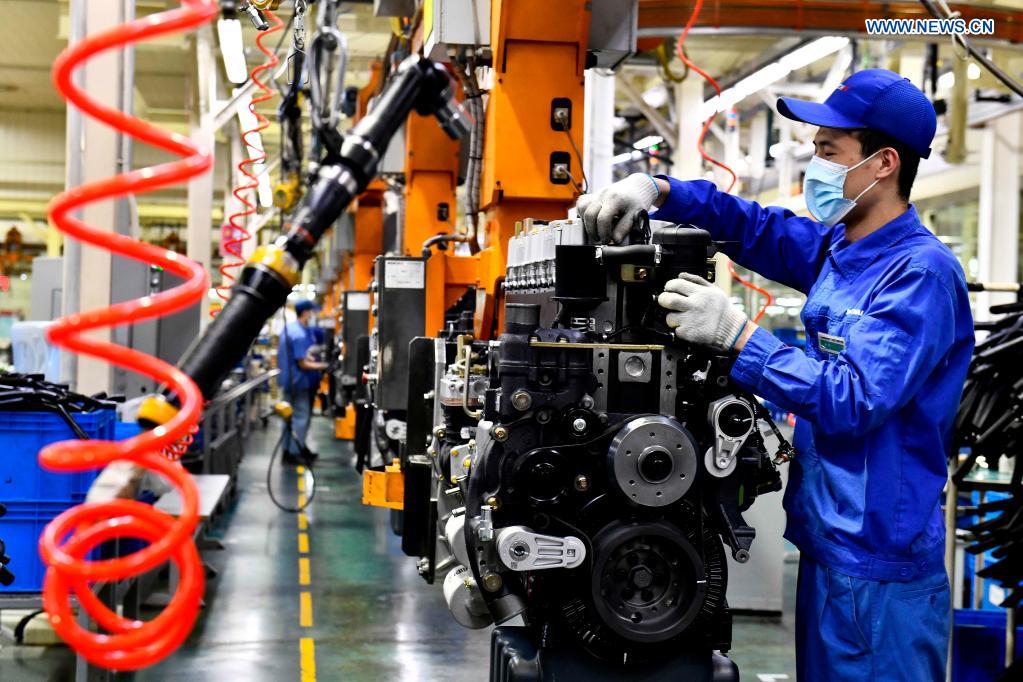 Workers assemble engines on an assembly line at a workshop of the Weichai Group in Weifang City, east China's Shandong province, April 22, 2021. The technology of producing high-end diesel engine used to be a bottleneck for China's equipment manufacturing industry. Weichai Power Co., Ltd., a state-owned enterprise founded in 1946, has developed China's first high-speed and high-power engine with completely independent intellectual property rights after more than ten years of scientific and technological research, completely ending China's long-term reliance on foreign technologies for heavy commercial vehicles. In 2018, Weichai won the first prize of the State Scientific and Technological Progress Award, and embarked on a path towards international market and high-quality development. (Xinhua/Guo Xulei)