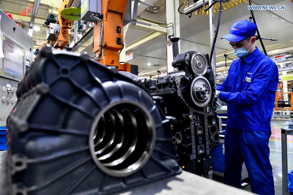 A worker assembles engines on an assembly line at a workshop of the Weichai Power Co., Ltd. in Weifang City, east China's Shandong province, April 22, 2021. The technology of producing high-end diesel engine used to be a bottleneck for China's equipment manufacturing industry. Weichai Power Co., Ltd., a state-owned enterprise founded in 1946, has developed China's first high-speed and high-power engine with completely independent intellectual property rights after more than ten years of scientific and technological research, completely ending China's long-term reliance on foreign technologies for heavy commercial vehicles. In 2018, Weichai won the first prize of the State Scientific and Technological Progress Award, and embarked on a path towards international market and high-quality development. (Xinhua/Guo Xulei)