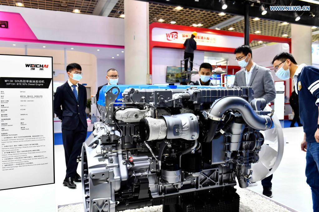 People view an engine presented by Weichai Power Co., Ltd. at the 2nd World Congress on Internal Combustion Engines in Jinan, east China's Shandong Province, April 21, 2021. The technology of producing high-end diesel engine used to be a bottleneck for China's equipment manufacturing industry. Weichai Power Co., Ltd., a state-owned enterprise founded in 1946, has developed China's first high-speed and high-power engine with completely independent intellectual property rights after more than ten years of scientific and technological research, completely ending China's long-term reliance on foreign technologies for heavy commercial vehicles. In 2018, Weichai won the first prize of the State Scientific and Technological Progress Award, and embarked on a path towards international market and high-quality development. (Xinhua/Guo Xulei)