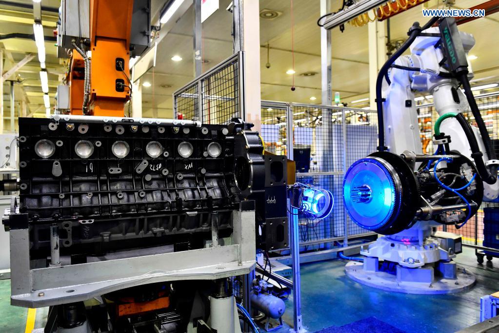 Robotic arms assemble engines on an assembly line at a workshop of the Weichai Power Co., Ltd. in Weifang City, east China's Shandong province, April 22, 2021. The technology of producing high-end diesel engine used to be a bottleneck for China's equipment manufacturing industry. Weichai Power Co., Ltd., a state-owned enterprise founded in 1946, has developed China's first high-speed and high-power engine with completely independent intellectual property rights after more than ten years of scientific and technological research, completely ending China's long-term reliance on foreign technologies for heavy commercial vehicles. In 2018, Weichai won the first prize of the State Scientific and Technological Progress Award, and embarked on a path towards international market and high-quality development. (Xinhua/Guo Xulei)