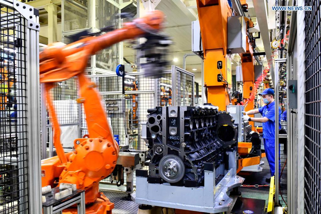 Robotic arms assemble engines on an assembly line at a workshop of the Weichai Power Co., Ltd. in Weifang City, east China's Shandong province, April 22, 2021. The technology of producing high-end diesel engine used to be a bottleneck for China's equipment manufacturing industry. Weichai Power Co., Ltd., a state-owned enterprise founded in 1946, has developed China's first high-speed and high-power engine with completely independent intellectual property rights after more than ten years of scientific and technological research, completely ending China's long-term reliance on foreign technologies for heavy commercial vehicles. In 2018, Weichai won the first prize of the State Scientific and Technological Progress Award, and embarked on a path towards international market and high-quality development. (Xinhua/Guo Xulei)