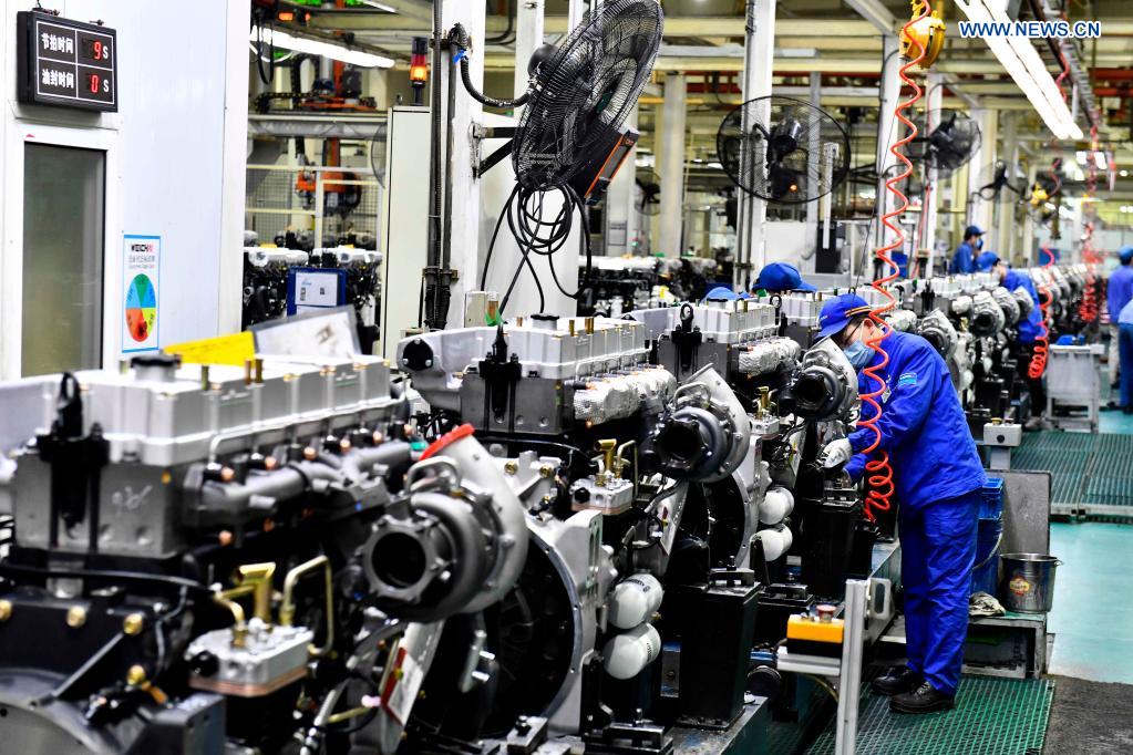 Workers assemble engines on an assembly line at a workshop of the Weichai Power Co., Ltd. in Weifang City, east China's Shandong province, April 22, 2021. The technology of producing high-end diesel engine used to be a bottleneck for China's equipment manufacturing industry. Weichai Power Co., Ltd., a state-owned enterprise founded in 1946, has developed China's first high-speed and high-power engine with completely independent intellectual property rights after more than ten years of scientific and technological research, completely ending China's long-term reliance on foreign technologies for heavy commercial vehicles. In 2018, Weichai won the first prize of the State Scientific and Technological Progress Award, and embarked on a path towards international market and high-quality development. (Xinhua/Guo Xulei)