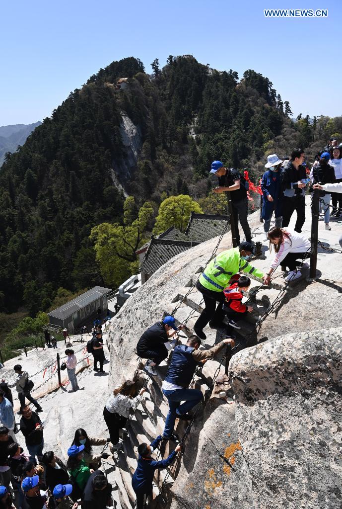 Tourists visit Mount Huashan scenic spot in northwest China's Shaanxi Province, May 5, 2021. During the five-day May Day holiday, the scenic spot received about 110,000 visits as of 4 p.m. Wednesday. (Xinhua/Tao Ming)