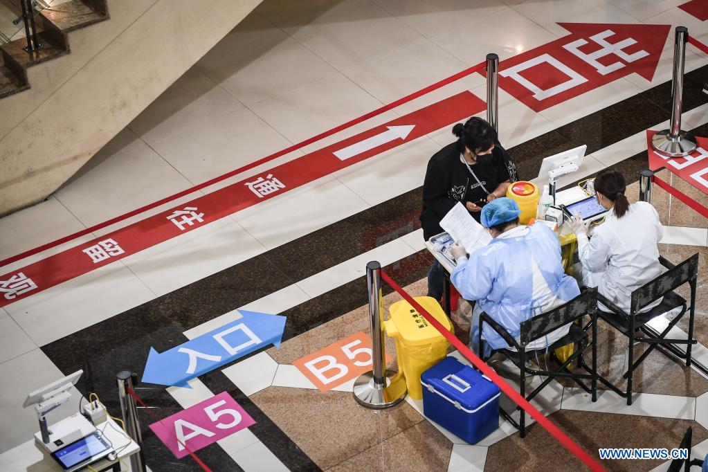 A woman prepares to receive the COVID-19 vaccine at a vaccination site in Dadong District of Shenyang, northeast China's Liaoning Province, May 7, 2021. The vaccination site, which was transformed from a sports center, went into service on Friday. Covering 4,000 square meters, the site is divided into 8 areas including temperature measuring area, waiting area, registration area, and etc. (Xinhua/Pan Yulong)