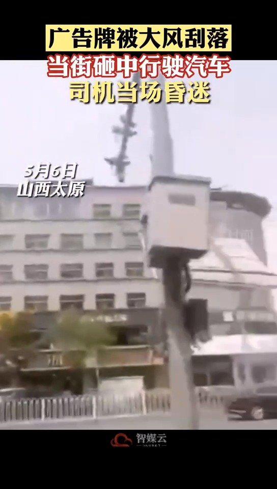 一处广告牌被大风刮落，当街砸中黑色轿车……