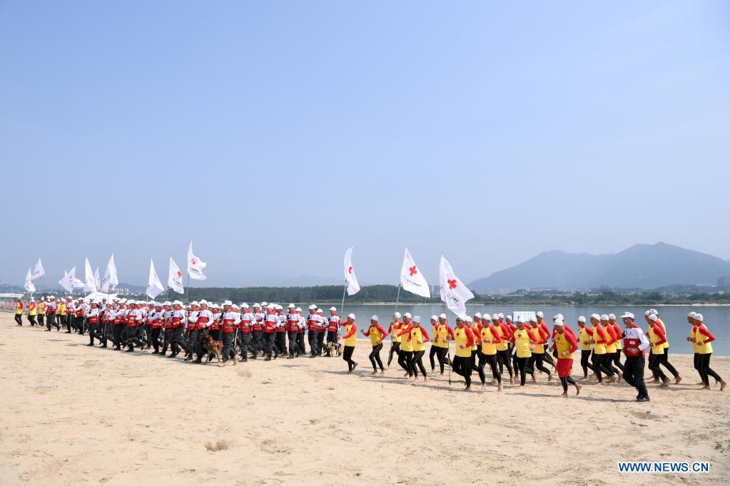 Rescuers assemble at the opening ceremony of an emergency rescue drill in Fuzhou, capital of southeast China's Fujian Province, May 10, 2021. A comprehensive emergency rescue drill hosted by the Red Cross Society of China was held in Fuzhou on Monday. A total of 13 Red Cross rescue teams from all over the country and the Donghai No.2 flying rescue service participated in the drill and systematically exercised rescue subjects like aquatic lifesaving, search and rescue, medical treatment, water supply and etc., in an effort to improve the joint rescue capability of various rescue teams at different levels. (Xinhua/Jiang Kehong)