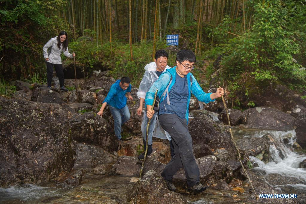 Researcher Yong Fan (1st R) from Nanjing Institute of Environmental Sciences crosses a river when conducting a survey on mammals in Longquan City of east China's Zhejiang Province, May 11, 2021. Located in the mountainous area in southwestern Zhejiang Province, Longquan City enjoys a favorable ecological environment and is known for its abundant biodiversity resources in east China. At present, the Nanjing Institute of Environmental Sciences under the Ministry of Ecology and Environment is organizing experts to continuously investigate the biodiversity in Longquan City. It will set up an electronic catalogue of specimens and a database for the species here, so as to lay a foundation for comprehensively improving biodiversity protection. (Xinhua/Jiang Han)