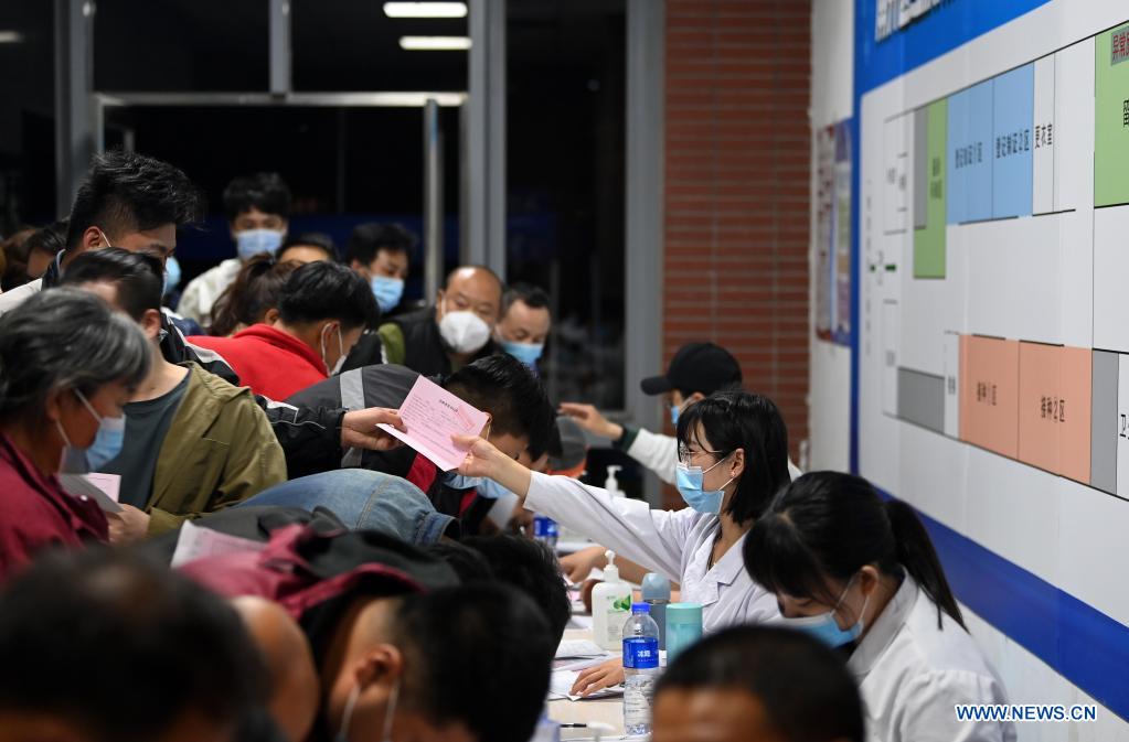 Couriers register information before getting administered against COVID-19 at a vaccination site in Nankai District, north China's Tianjin, May 12, 2021. A temporary vaccination site was launched to administer the second dose of COVID-19 vaccine for more than 1,000 deliverymen at Hongqi South Road of Nankai District, north China's Tianjin. The vaccination was arranged at night, in order not to affect the couriers' delivery work during the daytime. (Xinhua/Li Ran)