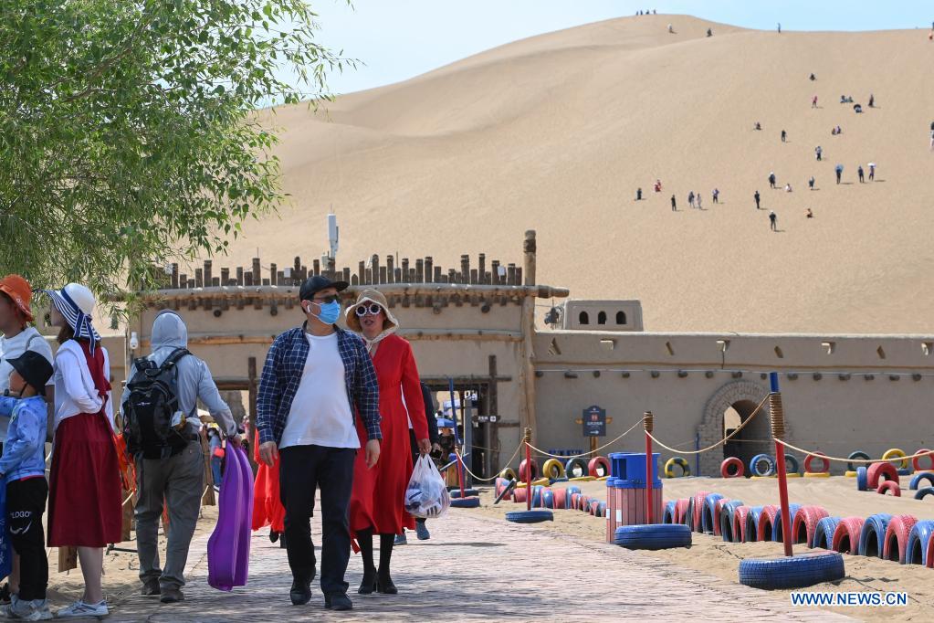 People visit Kumtag Desert in Shanshan County, northwest China's Xinjiang Uygur Autonomous Region, May 16, 2021. The county sees boom in desert tourism early May. (Xinhua/Ding Lei)