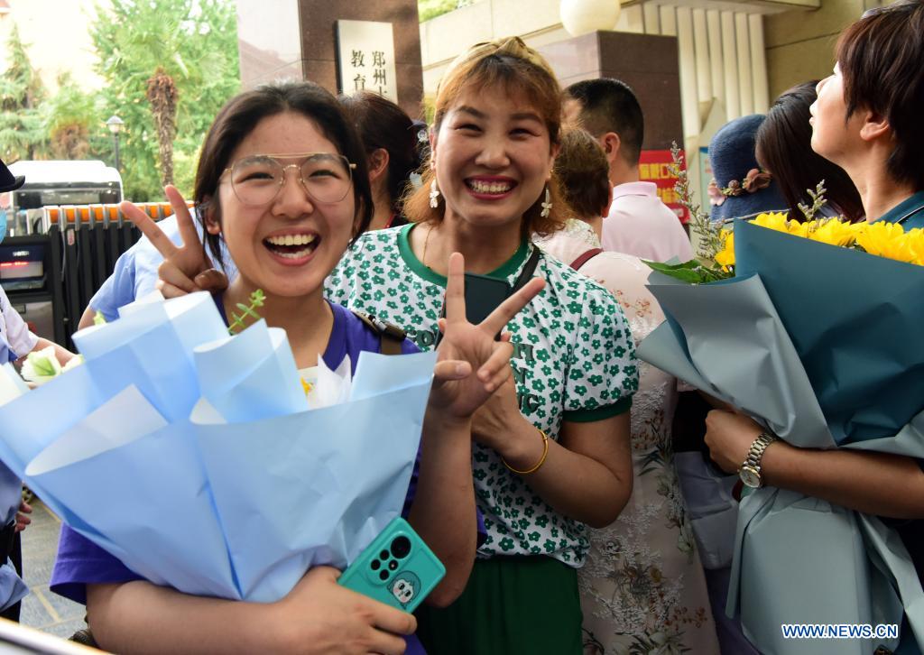  An examinee is greeted by her parent while walking out of an exam site at a high school in Zhengzhou, the capital city of central China's Henan Province, June 8, 2021. China's annual college entrance exam concluded on Tuesday in some parts of the country. Considered the world's most grueling test, the exam, better known as the Gaokao, saw a record 10.78 million candidates signing up this year. (Xinhua/Zhu Xiang)